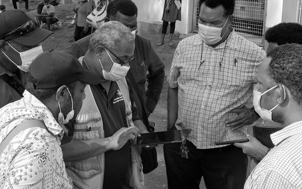 Health workers in the field using a tablet